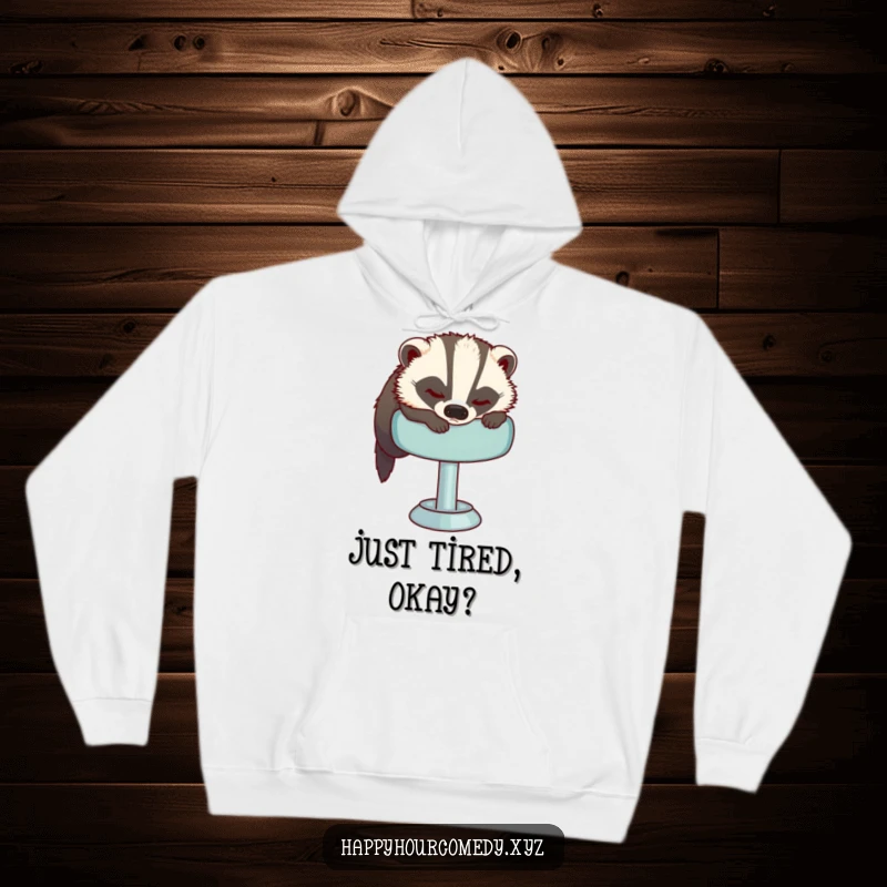 Funny Sleepy Badger Hoodie depicts a tired badger trying to get comfortable on a plush bar stool, offering warmth and a sense of peace.